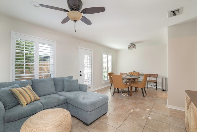 tiled living room with ceiling fan