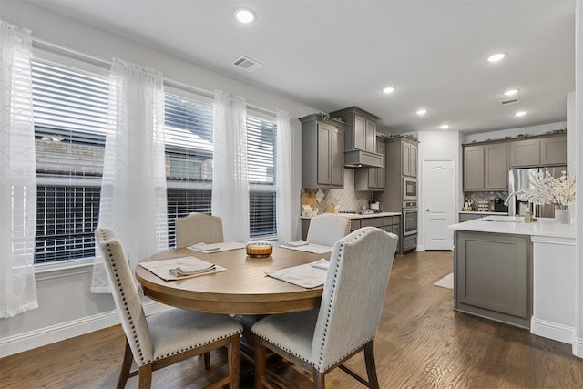 dining room featuring dark hardwood / wood-style flooring and sink