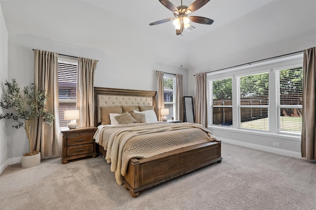 bedroom with lofted ceiling, light colored carpet, and ceiling fan