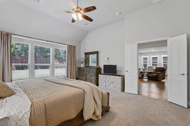 carpeted bedroom with high vaulted ceiling and ceiling fan