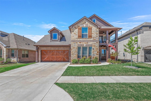 view of front of house featuring a garage, a balcony, and a front lawn