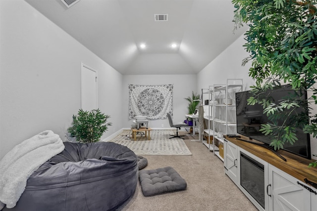 living room with lofted ceiling and light colored carpet