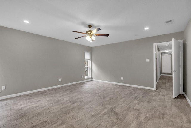 spare room with ceiling fan and light hardwood / wood-style flooring