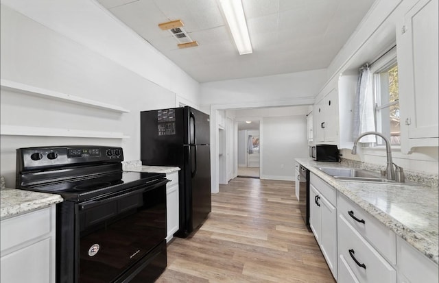 kitchen featuring black appliances, sink, light stone countertops, light wood-type flooring, and white cabinetry