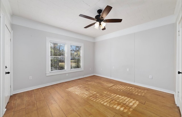 spare room with ceiling fan, crown molding, and hardwood / wood-style flooring