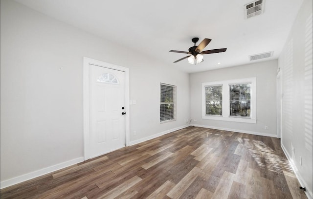 interior space with ceiling fan and dark hardwood / wood-style floors