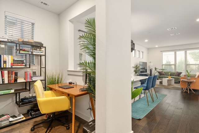 home office with dark hardwood / wood-style floors