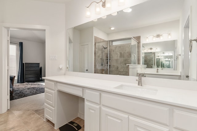 bathroom featuring tile patterned flooring, vanity, and a shower with shower door