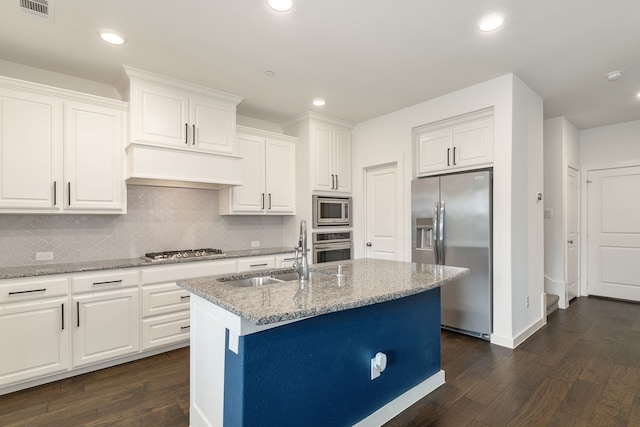 kitchen with premium range hood, sink, white cabinetry, a center island with sink, and stainless steel appliances