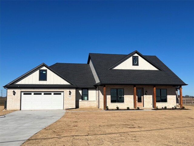 view of front facade featuring covered porch and a garage