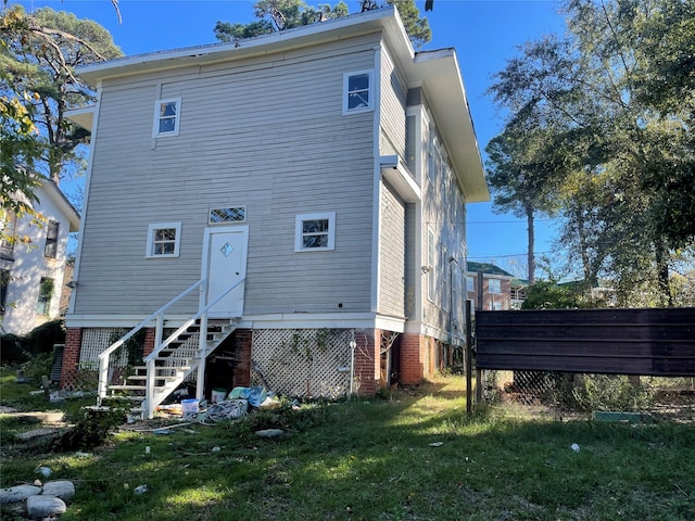 back of house with a lawn