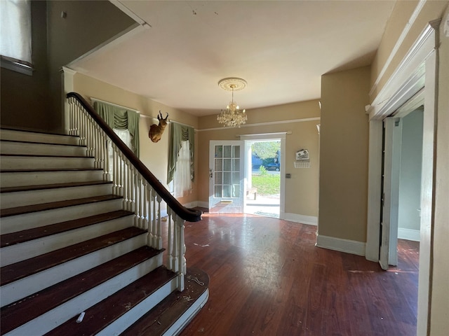 entrance foyer with a chandelier and dark wood-type flooring