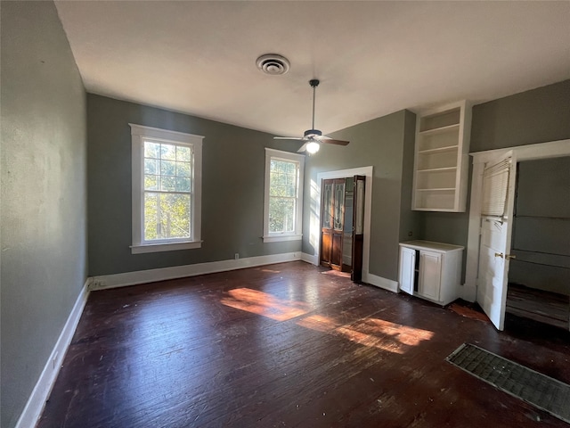 interior space with ceiling fan and dark wood-type flooring