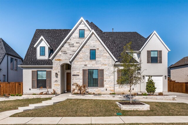 view of front of property featuring a garage and a front yard