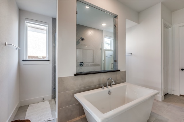 bathroom featuring tile patterned floors, tile walls, and shower with separate bathtub