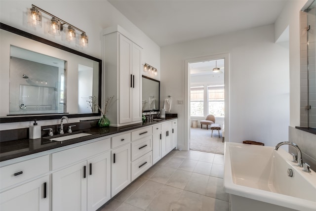 bathroom featuring tile patterned floors, vanity, and a shower