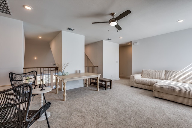 carpeted living room with ceiling fan