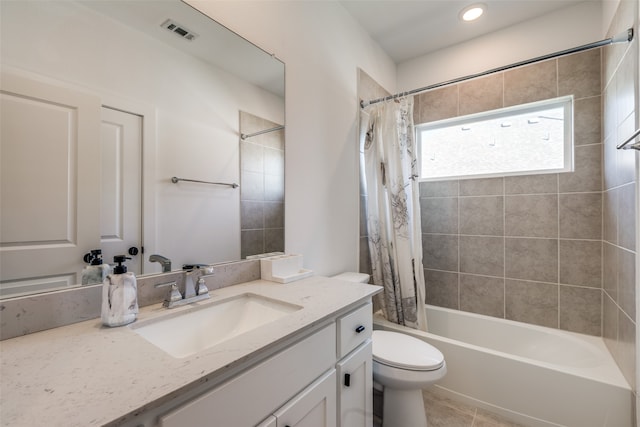 full bathroom with tile patterned flooring, shower / bath combo, vanity, and toilet