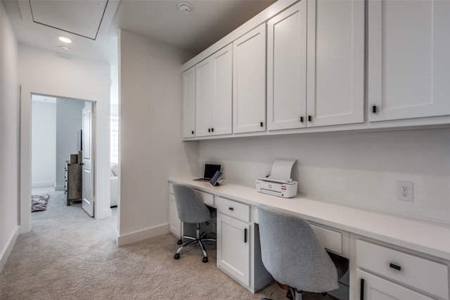 office with light carpet and built in desk