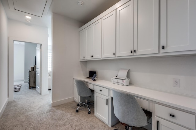 office area with light carpet and built in desk