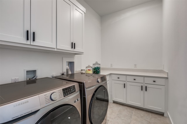 washroom with cabinets, independent washer and dryer, and light tile patterned flooring