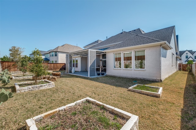 rear view of property with a yard, a pergola, and a patio