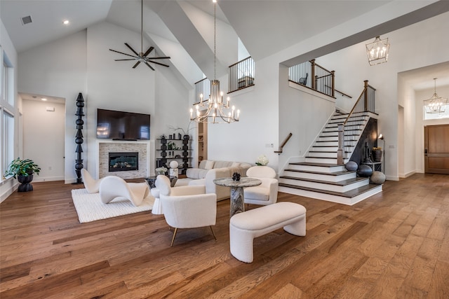 living room featuring a fireplace, high vaulted ceiling, and hardwood / wood-style flooring