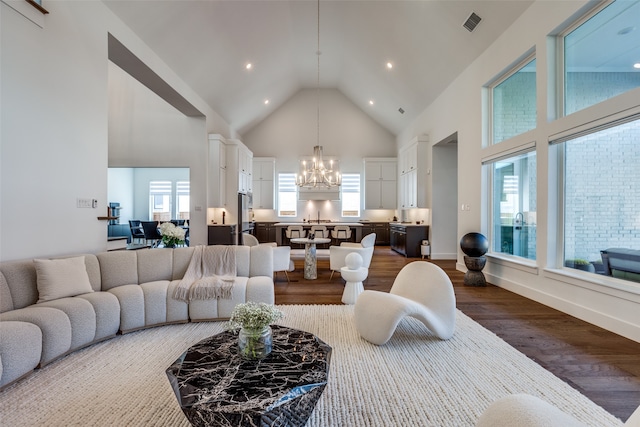 living room with sink, dark hardwood / wood-style flooring, high vaulted ceiling, and an inviting chandelier