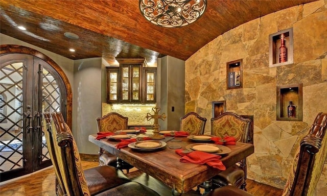 dining room with french doors, wood-type flooring, vaulted ceiling, and wooden ceiling