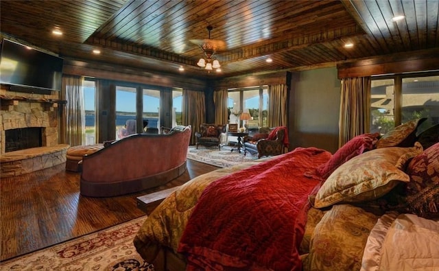 bedroom with wood ceiling, wood-type flooring, a fireplace, and access to exterior