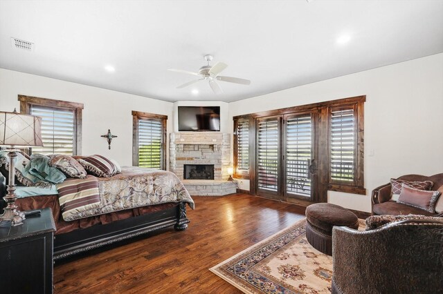5101 Hells Gate Loop, Possum Kingdom Lake, TX 76475 - bedroom featuring access to outside, wood finished floors, a stone fireplace, recessed lighting, and ceiling fan