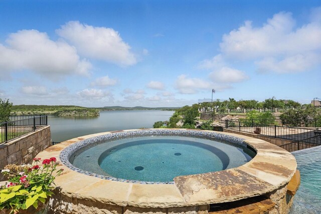 5101 Hells Gate Loop, Possum Kingdom Lake, TX 76475 - view of patio featuring exterior fireplace, exterior kitchen, and a water view