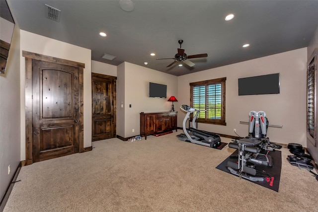 workout area featuring ceiling fan and carpet flooring