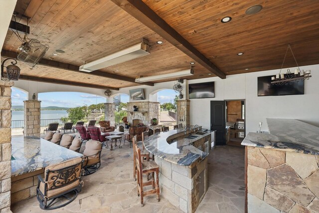 5101 Hells Gate Loop, Possum Kingdom Lake, TX 76475 - view of patio / terrace with an outdoor stone fireplace and a water view