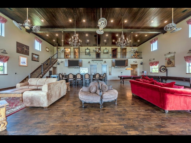 living room with dark hardwood / wood-style flooring, a chandelier, a high ceiling, wood ceiling, and beam ceiling