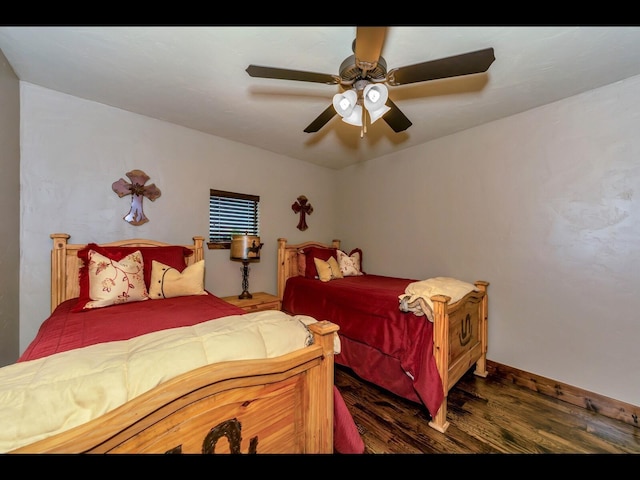 bedroom featuring dark hardwood / wood-style floors and ceiling fan