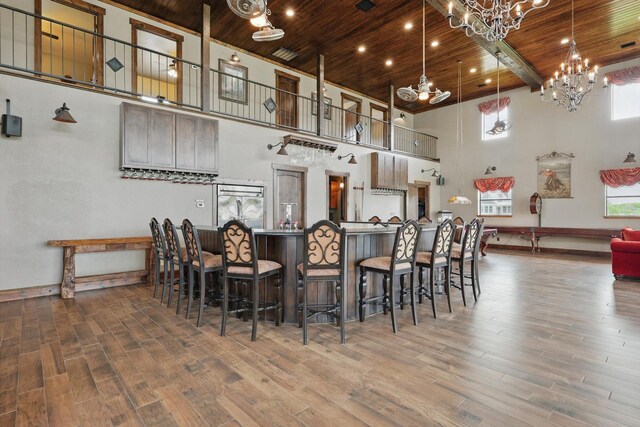 5101 Hells Gate Loop, Possum Kingdom Lake, TX 76475 - living room with wood finished floors, recessed lighting, wood ceiling with exposed beams, a high ceiling, and french doors