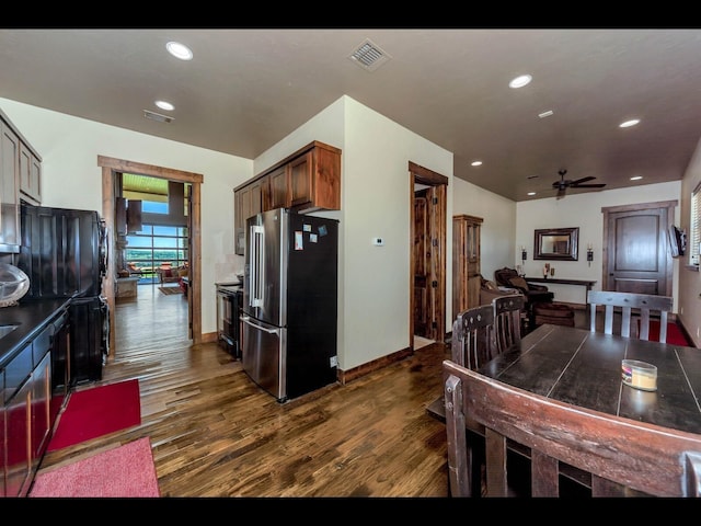 kitchen featuring dark hardwood / wood-style flooring, black appliances, and ceiling fan