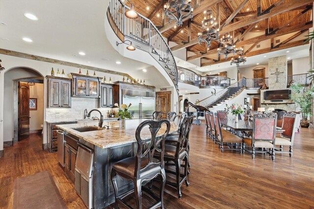 5101 Hells Gate Loop, Possum Kingdom Lake, TX 76475 - living area with a towering ceiling, healthy amount of natural light, wood finished floors, baseboards, and stairs