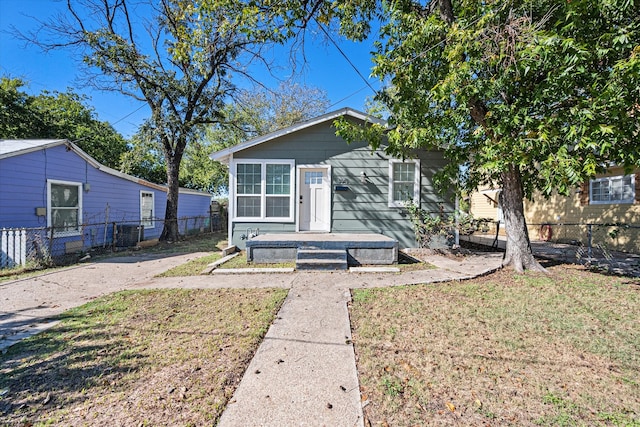 bungalow-style home with a front lawn