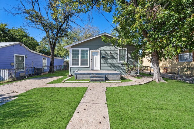 bungalow-style house with a front yard