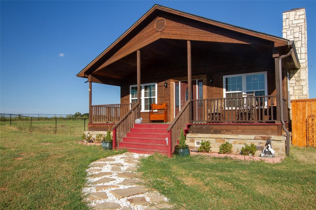 view of front of home with a porch and a front yard