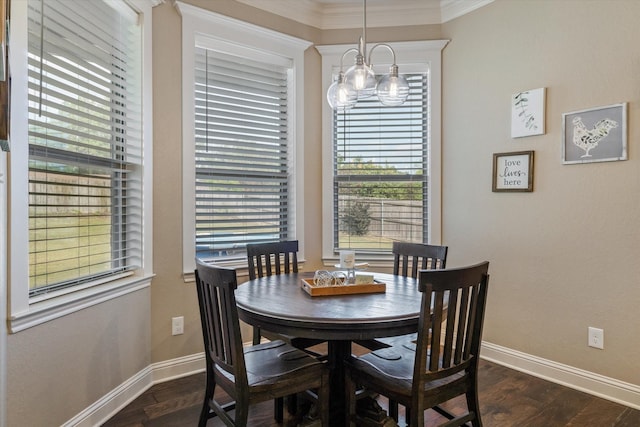 dining room with ornamental molding, a notable chandelier, and dark hardwood / wood-style flooring