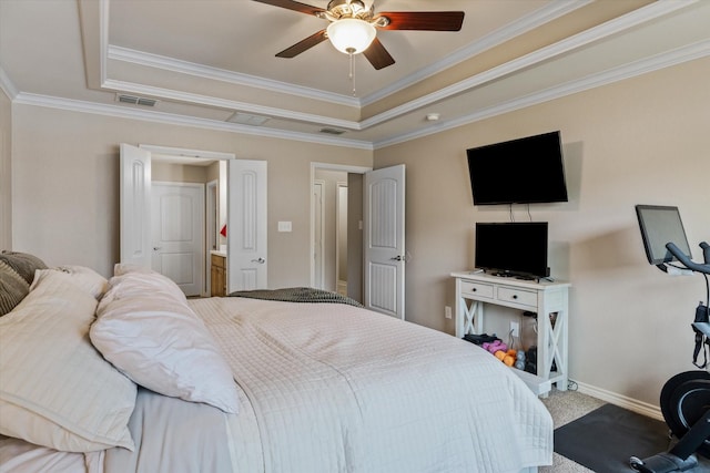 carpeted bedroom with crown molding, connected bathroom, a tray ceiling, and ceiling fan