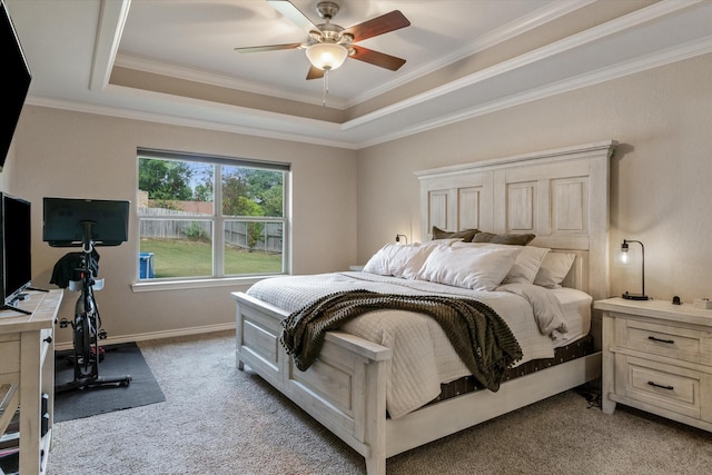 carpeted bedroom with crown molding, a raised ceiling, and ceiling fan