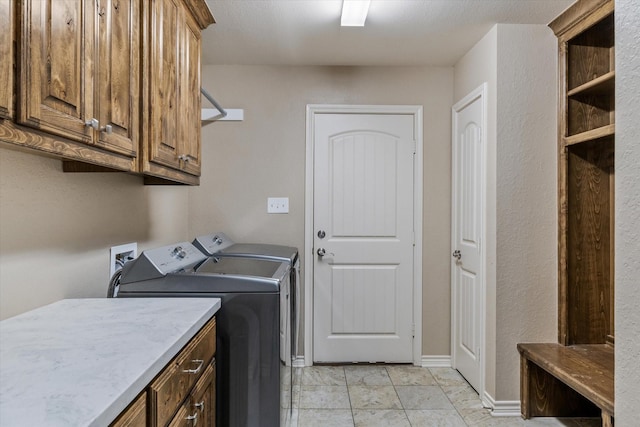 laundry area featuring cabinets and washer and clothes dryer