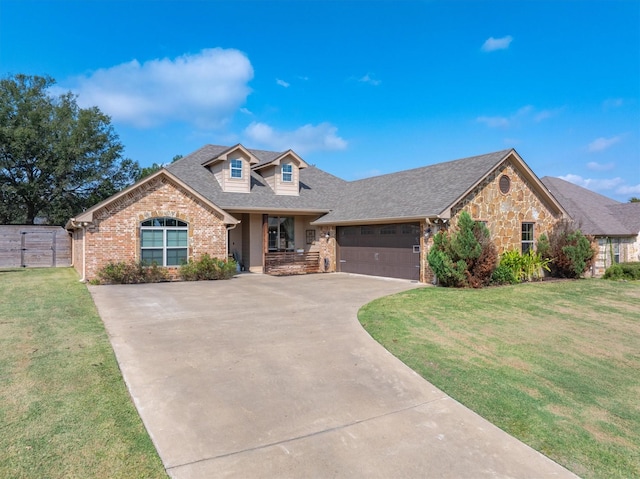 view of front of property featuring a garage and a front lawn