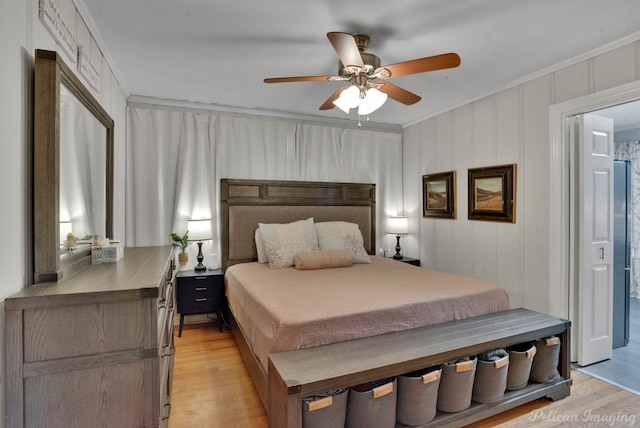 bedroom featuring ceiling fan, light hardwood / wood-style floors, and crown molding