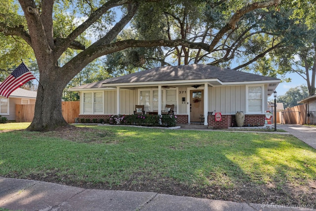 single story home with a porch and a front yard