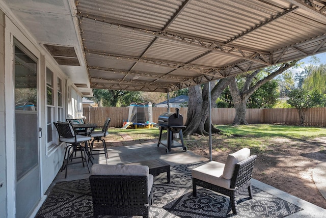 view of patio with a grill and a trampoline